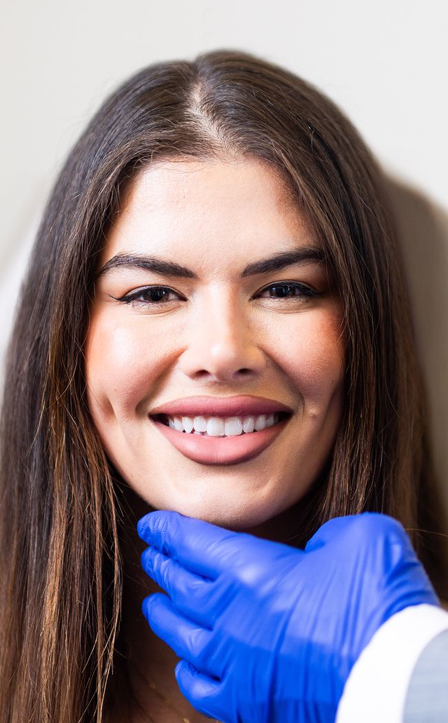 Woman smiling during a dental consultation.