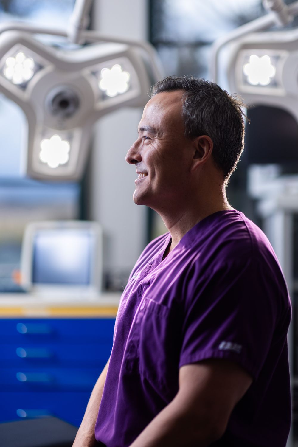 Male healthcare professional in surgical attire.