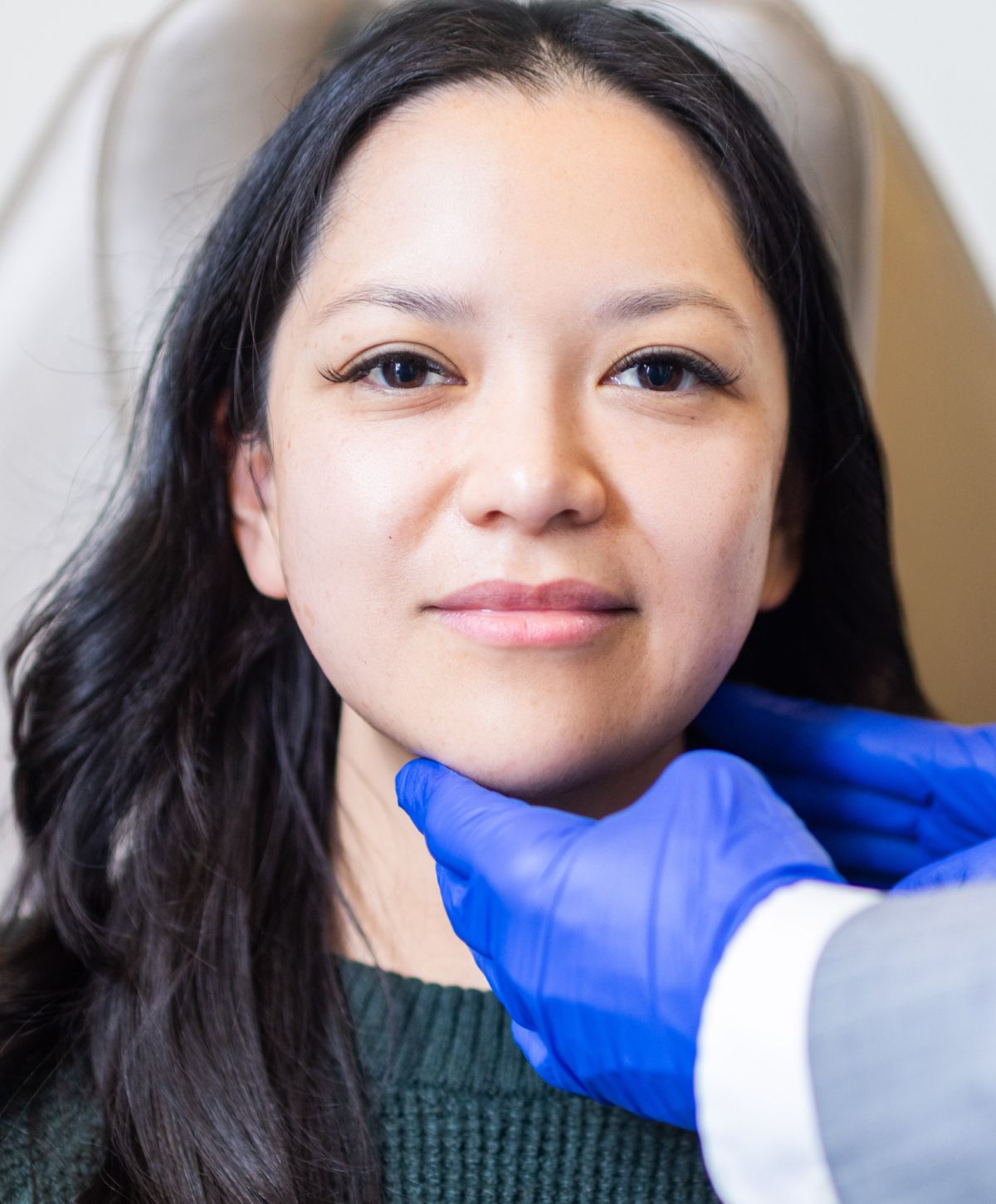 Facial assessment by a professional in clinic.