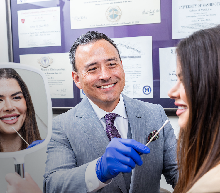 Dentist examining patient with dental mirror.