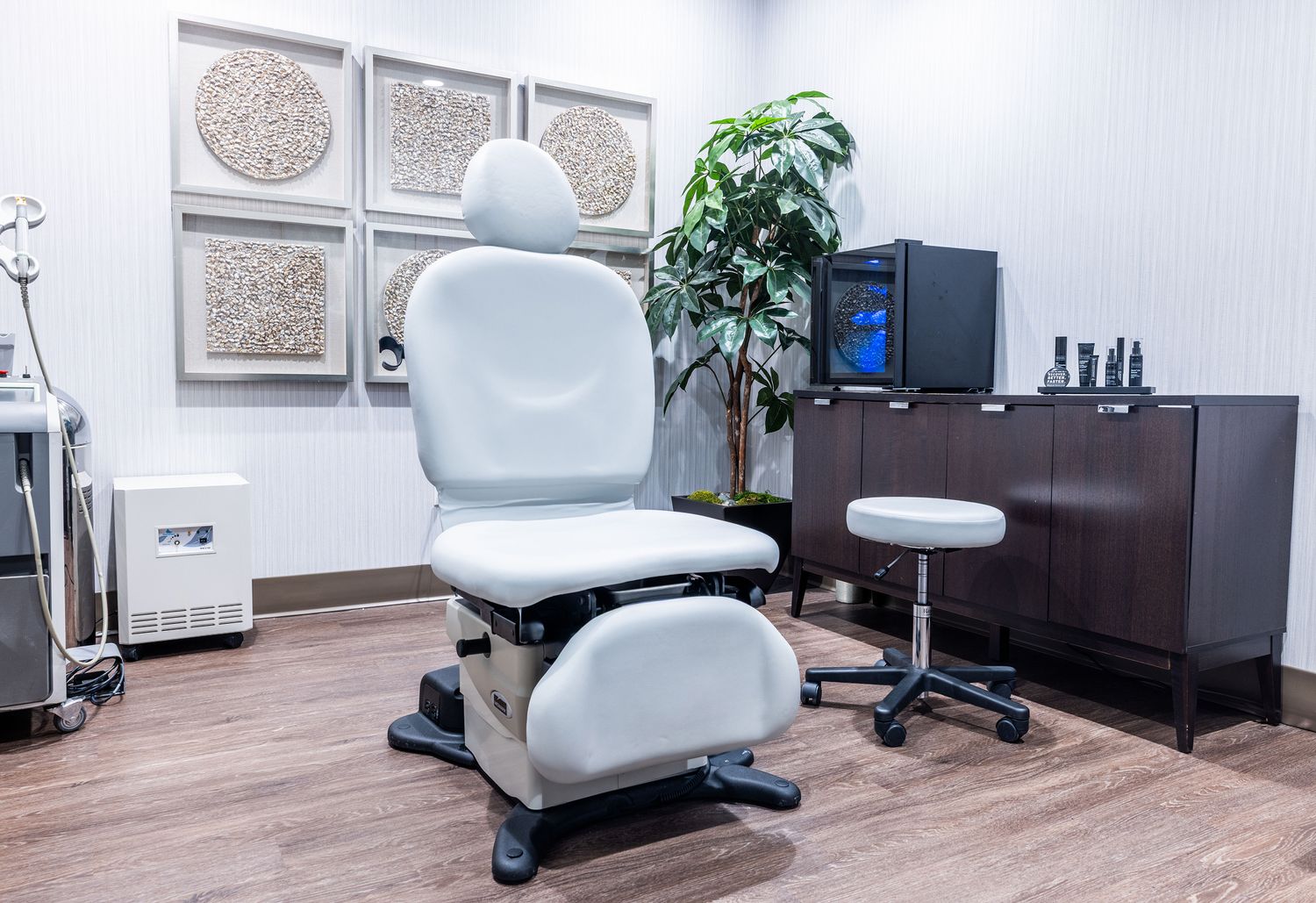 Medical treatment room with adjustable chairs and decor.