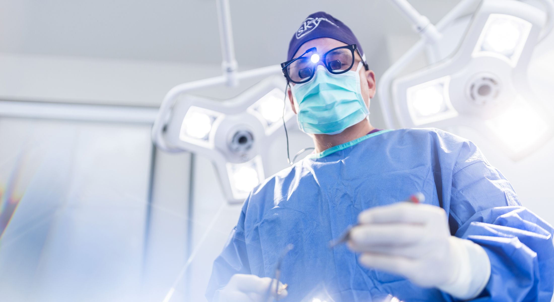 Surgeon performing surgery in an operating room.