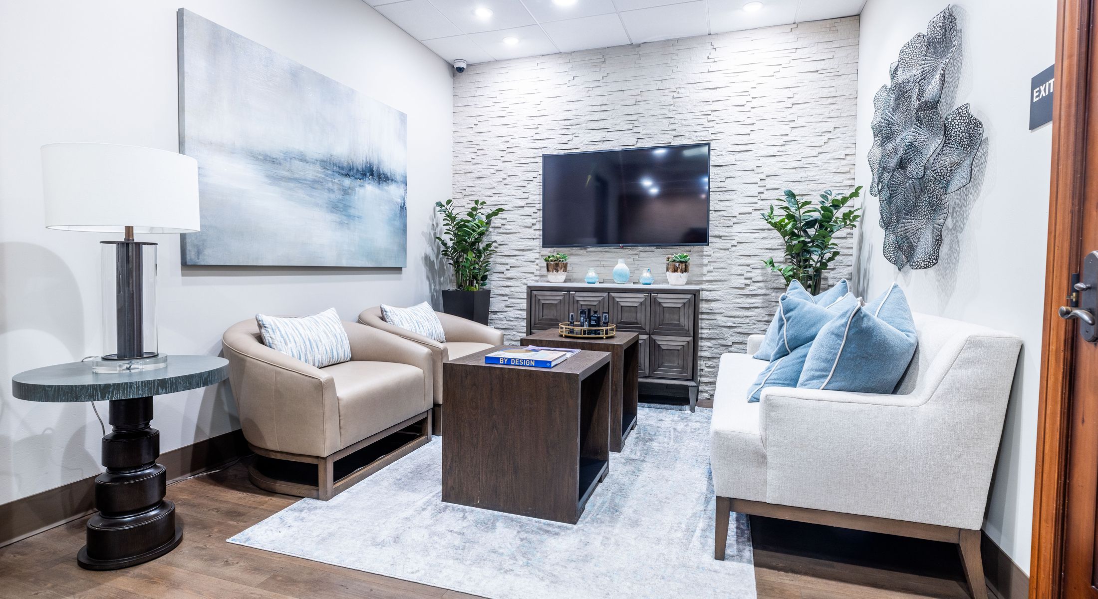 Modern waiting room with comfortable seating and decor.