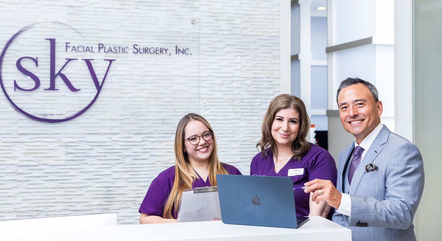 Reception team at facial plastic surgery office.